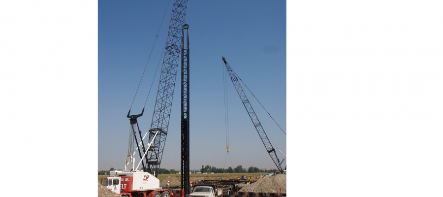 Crews drive pylons into the ground for testing