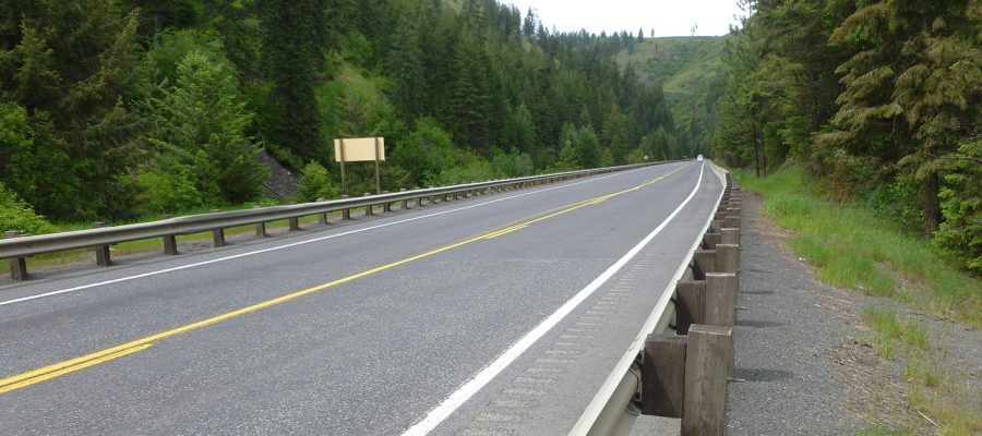 US-95 climbs through a green Culdesac Canyon.