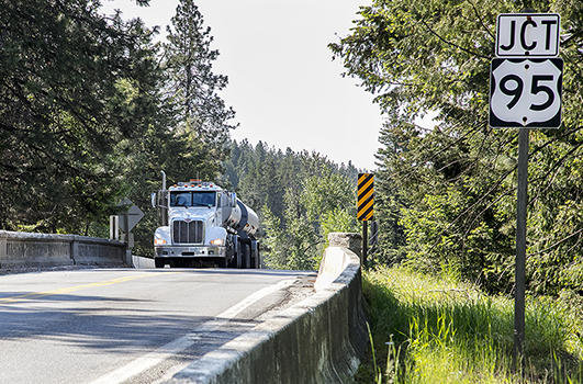 A truck crosses the railroad bridge on ID-53 just west of US-95.