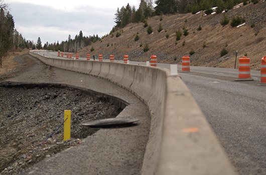 Barrels and guardrail separate traffic on US-95 from the Rock Creek slide.