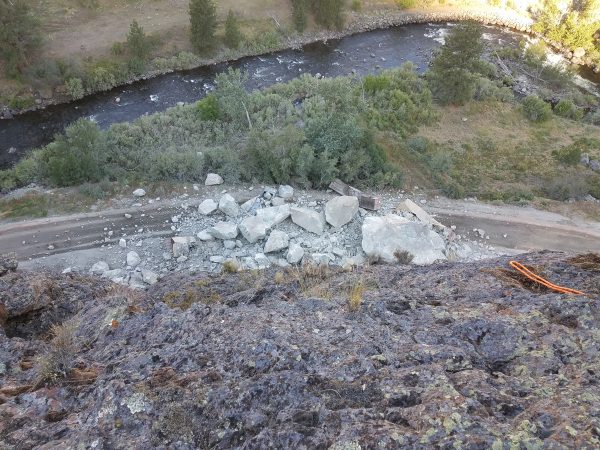 Photo from the top of the failing slope on US-95 at milepost 188 looking at massive boulders