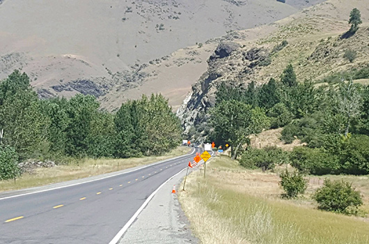 Traffic runs on a temporary road around the debris field on US-95
