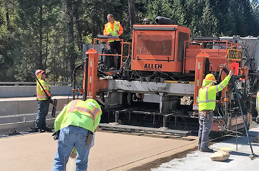 Photo of contractors redoing the driving surface on the westbound bridge over Blue Creek Bay