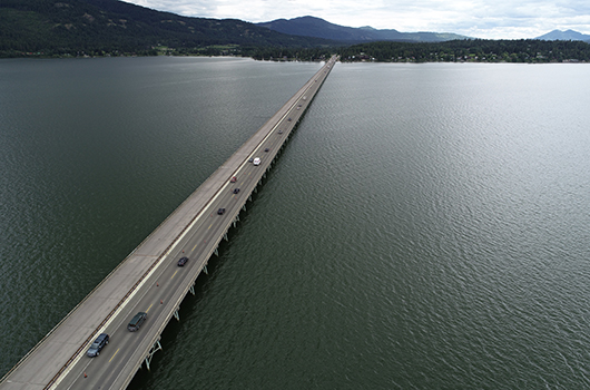 Cars cross Lake Pend Oreille on the Long Bridge