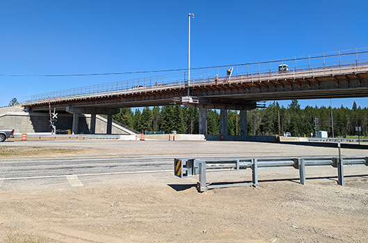 View from the ground of workers preparing to open the overpass for US-95 at Garwood Road to traffic