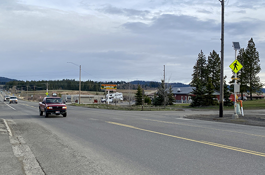 A red truck drivers through Plummer on US-95