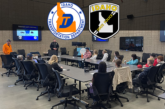 Picture of a ISP trooper and a ITD operator presenting to a classroom and sharing winter driving tips.