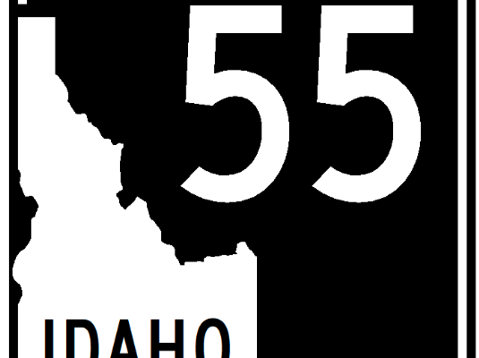 Graphic showing a State Highway 55 road sign with a white background and black outline. The sign reads “Idaho 55” with the state shape and shield design typical of Idaho highway markers.